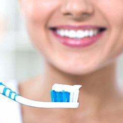 Woman smiling holding toothbrush